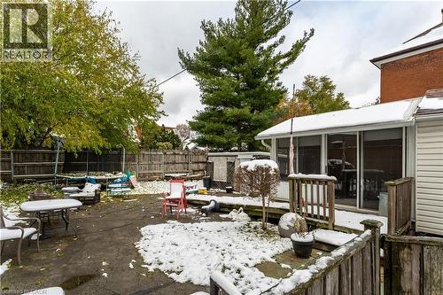Fenced backyard featuring a sunroom, a patio, and a wooden deck - 193 Locke Street N, Hamilton, ON - Outdoor