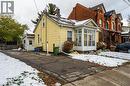 View of snowy exterior with a chimney and a sunroom - 193 Locke Street N, Hamilton, ON  - Outdoor 