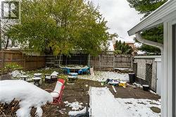 Snowy yard with a patio and a fenced backyard - 