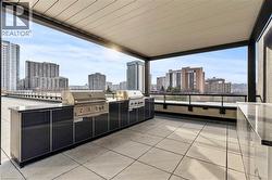 View of patio / terrace featuring an outdoor kitchen and a city view - 
