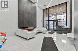Community lobby featuring a high ceiling, expansive windows, and recessed lighting - 