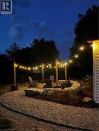 Yard at twilight featuring a patio area and a fire pit - 