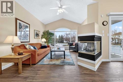 Vinyl flooring throughout is pet friendly, kid-proof and easy care - 509 Riverview Place Se, Calgary, AB - Indoor Photo Showing Living Room With Fireplace