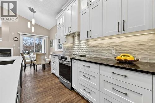 Undercounter lighting as well as lighting in upper cabinets - efficient and beautiful - 509 Riverview Place Se, Calgary, AB - Indoor Photo Showing Kitchen With Upgraded Kitchen