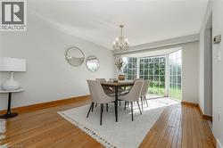 Dining room featuring light wood-type flooring and a chandelier - 