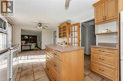 Kitchen featuring ceiling fan, white electric range oven, light countertops, and dishwasher - 