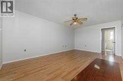 Unfurnished room with light wood-style floors, ceiling fan, and a textured ceiling - 
