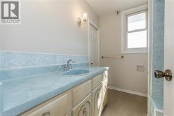 Full bathroom featuring vanity and dark tile patterned flooring - 