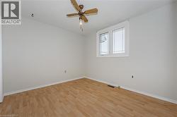 Spare room featuring light wood-type flooring and a ceiling fan - 