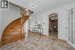 Stairs featuring arched walkways and baseboards - 