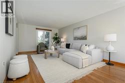 Living area with wood-type flooring, arched walkways, and a textured ceiling - 
