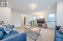 Carpeted living area featuring baseboards and recessed lighting - 