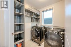 Laundry room with washer and clothes dryer and a textured ceiling - 