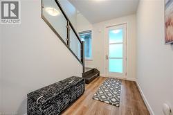 Entryway with stairs and wood finished floors - 