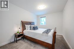 Carpeted bedroom with a textured ceiling and baseboards - 