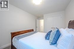 Bedroom featuring a textured ceiling, a closet, and carpet - 