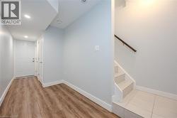Stairs with recessed lighting and wood finished floors - 
