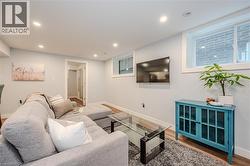 Living room with wood finished floors and recessed lighting - 