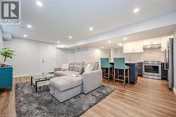 Living area with light wood finished floors and recessed lighting - 