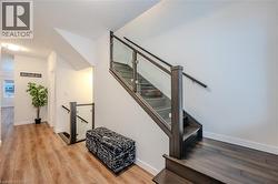 Stairway featuring wood finished floors and baseboards - 