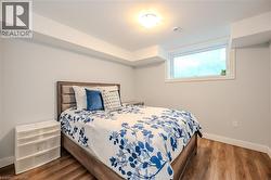 Bedroom with wood finished floors and baseboards - 