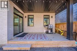 View of patio featuring area for grilling and a wooden deck - 