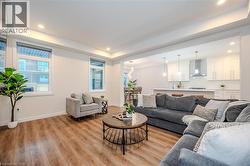 Living area featuring light wood finished floors and recessed lighting - 