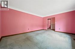 Unfurnished room featuring baseboards and carpet floors - 