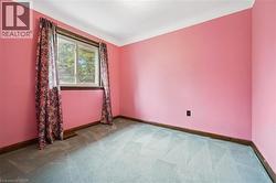 Unfurnished room featuring carpet and baseboards - 