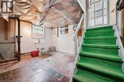 Basement with stairway and a sink - 