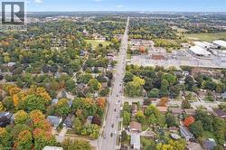 Aerial view of property and surrounding area with a tree filled landscape - 