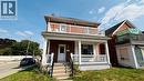 View of front of house with brick siding, covered porch, a front yard, a balcony, and a chimney - 30 Regina Street N, Waterloo, ON  - Outdoor With Deck Patio Veranda 