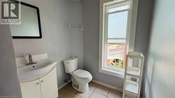 Bathroom with light tile patterned flooring, vanity, and a water view - 