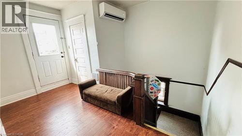 Entryway with wood finished floors and a wall unit AC - 30 Regina Street N, Waterloo, ON - Indoor