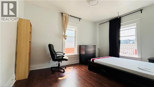 Bedroom featuring dark wood finished floors and a desk - 30 Regina Street N, Waterloo, ON - Indoor