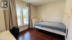 Bedroom with dark wood-style flooring - 