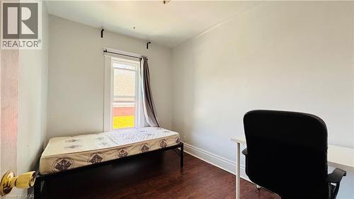 Bedroom with wood finished floors and an office area - 30 Regina Street N, Waterloo, ON - Indoor Photo Showing Bedroom