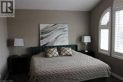 Carpeted bedroom with baseboards and lofted ceiling - 