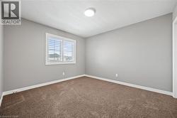 Carpeted empty room featuring visible vents and baseboards - 