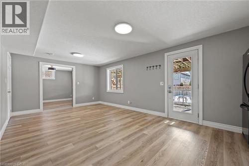 Empty room featuring light wood-style floors, baseboards, and a textured ceiling - 561 Thomas Slee Drive, Kitchener, ON - Indoor Photo Showing Other Room
