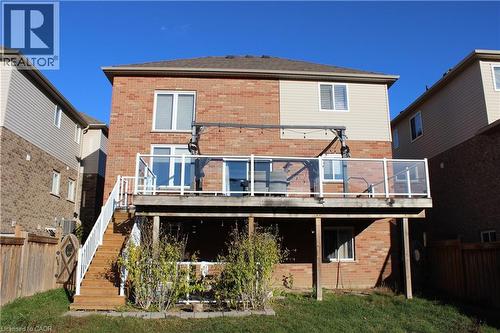 Rear view of house with brick siding, stairway, a deck, and a fenced backyard - 561 Thomas Slee Drive, Kitchener, ON - Outdoor With Deck Patio Veranda With Exterior