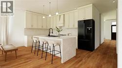 Kitchen with black fridge, a breakfast bar area, decorative light fixtures, tasteful backsplash, and light stone counters - 