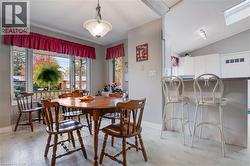 Dining room featuring vaulted ceiling and light floors - 