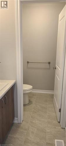 Bathroom with toilet, vanity, and baseboards - 17 Renfrew Trail, Welland, ON - Indoor Photo Showing Bathroom