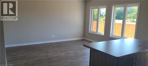 Unfurnished room featuring baseboards and dark wood finished floors - 17 Renfrew Trail, Welland, ON - Indoor Photo Showing Other Room