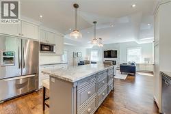 Kitchen featuring recessed lighting, open floor plan, appliances with stainless steel finishes, and gray cabinetry - 