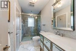 Bathroom featuring vanity, toilet, visible vents, and a stall shower - 