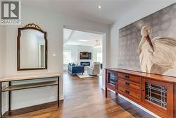 Hallway featuring recessed lighting, baseboards, and dark wood-style flooring - 