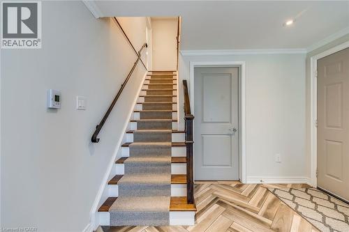Stairway featuring crown molding and baseboards - 4306 Lakeshore Road, Burlington, ON - Indoor Photo Showing Other Room