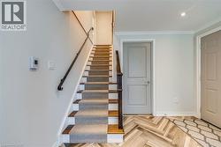 Stairway featuring crown molding and baseboards - 